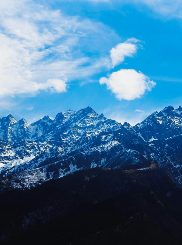 Stunning winter view of snow-covered Himalayan mountains under a bright blue sky.