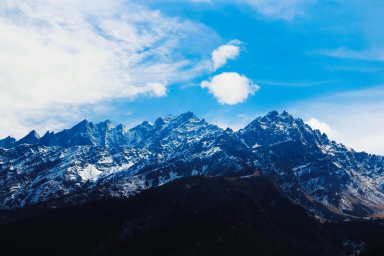 Stunning winter view of snow-covered Himalayan mountains under a bright blue sky.